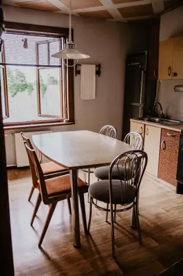 a dining room table and chairs in a kitchen at Hillas in Tauragnai