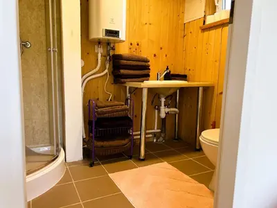 a bathroom with a sink and a toilet at Raimundėlio sodyba in Rokiškis