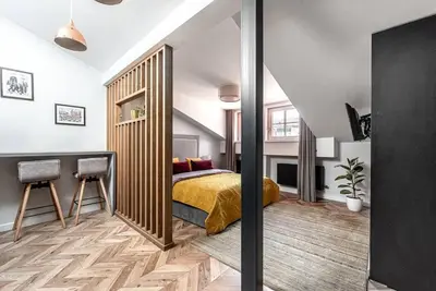 a bedroom with a bed and a desk in it at Studio apartment in Oldtown #F in Vilnius