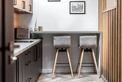 two chairs sitting at a counter in a kitchen at Studio apartment in Oldtown #F in Vilnius