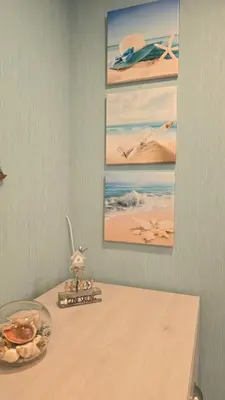a table with a glass bowl of food and pictures on the wall at Kristi Apartments in Visaginas