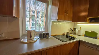 a kitchen with a sink and a counter top at Kristi Apartments in Visaginas