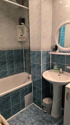 a bathroom with a sink and a tub and a toilet at Kristi Apartments in Visaginas