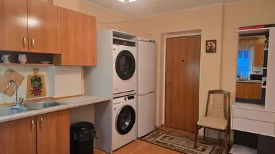 a kitchen with a washer and dryer next to a sink at Kristi Apartments in Visaginas