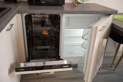an open refrigerator with its door open in a kitchen at Vita apartment in Vilnius