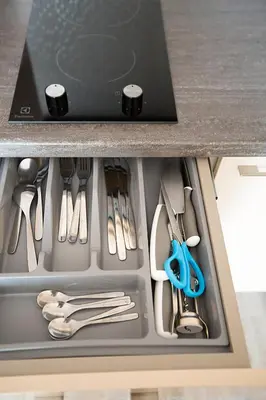 a drawer filled with utensils in a kitchen at Vita apartment in Vilnius