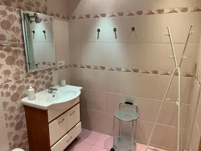 a bathroom with a sink and a mirror at Welcome apartment in Druskininkai
