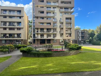 an apartment building with a park in front of it at Welcome apartment in Druskininkai