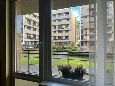 a window with a view of a building at Welcome apartment in Druskininkai