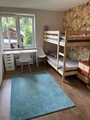 a bedroom with two bunk beds and a desk and a desk and bunk bed at Apartment 4 Palūšė in Palūšė