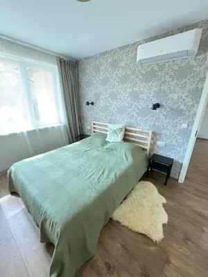 a bedroom with a bed with a green comforter at Apartment 4 Palūšė in Palūšė
