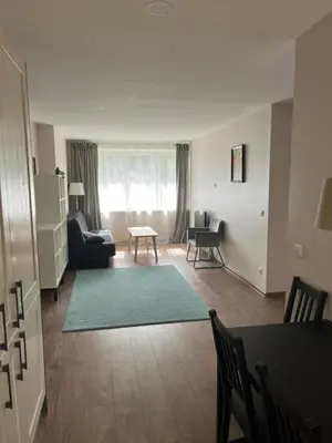 a living room with a couch and a table at Apartment 4 Palūšė in Palūšė