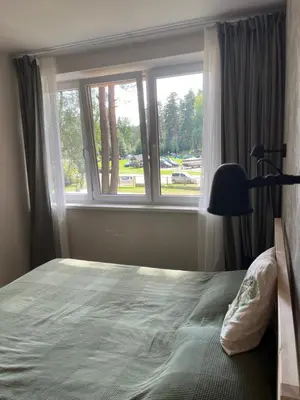 a bedroom with a large bed and a window at Apartment 4 Palūšė in Palūšė