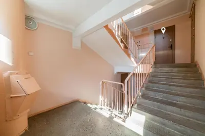 an empty hallway with stairs in a building at Amber Apartments in Šiauliai