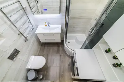 a bathroom with a sink and a shower and a toilet at Amber Apartments in Šiauliai