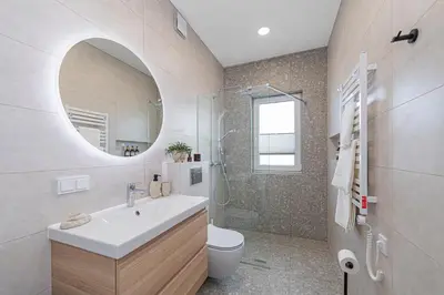 a bathroom with a sink and a toilet and a mirror at Charming 1 BD Apartment by Domvia in Kaunas