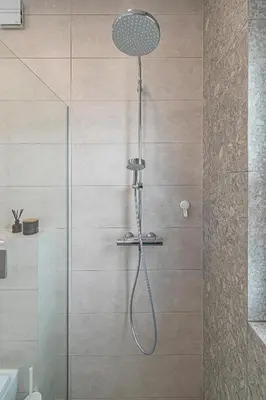 a shower with a shower head in a bathroom at Charming 1 BD Apartment by Domvia in Kaunas