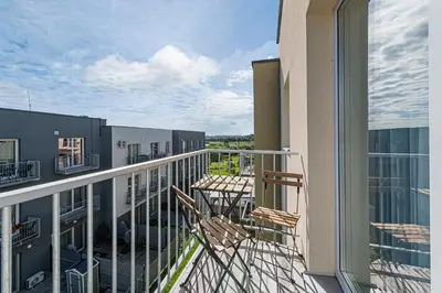 a balcony of a building with a table and chairs at Charming 1 BD Apartment by Domvia in Kaunas