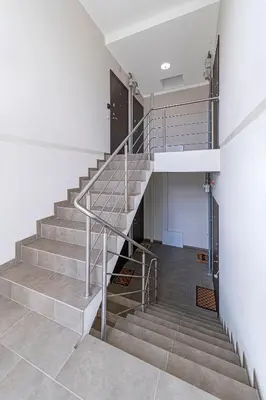a staircase in a building with a metal railing at Charming 1 BD Apartment by Domvia in Kaunas