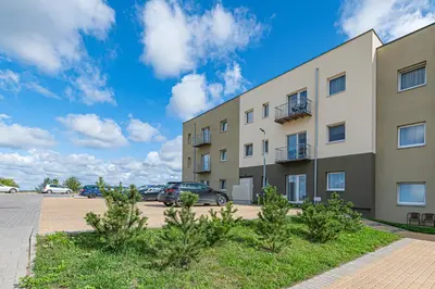 an apartment building with cars parked in a parking lot at Charming 1 BD Apartment by Domvia in Kaunas