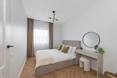 a bedroom with a bed with a mirror and a desk at Charming 1 BD Apartment by Domvia in Kaunas