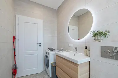 a bathroom with a sink and a washing machine at Charming 1 BD Apartment by Domvia in Kaunas