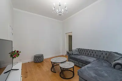 a living room with a couch and two tables at Riverside 1 BD Central Apartment by Hostlovers in Kaunas