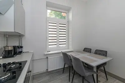 a kitchen with a table and chairs and a window at Riverside 1 BD Central Apartment by Hostlovers in Kaunas