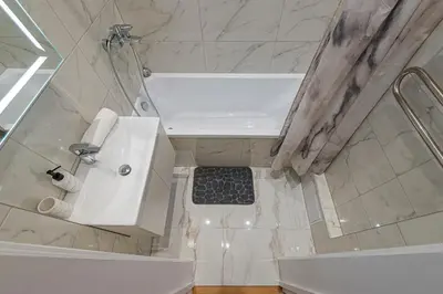 a bathroom with a tub and a sink and a shower at Riverside 1 BD Central Apartment by Hostlovers in Kaunas