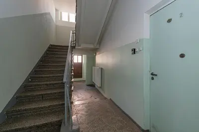 an empty hallway with stairs in a building at Riverside 1 BD Central Apartment by Hostlovers in Kaunas