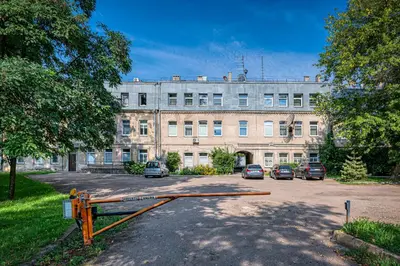 a large building with cars parked in front of it at Riverside 1 BD Central Apartment by Hostlovers in Kaunas