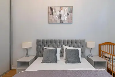 a bedroom with a large bed with two night stands at Riverside 1 BD Central Apartment by Hostlovers in Kaunas