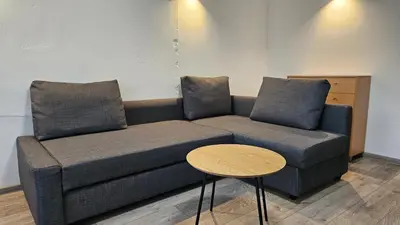 a living room with a couch and a table at Draugyste Apartment in Šiauliai