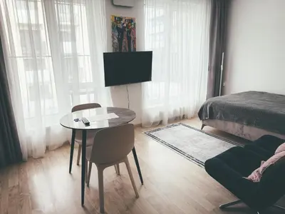 a bedroom with a table and a bed and a tv at Apartment with a large balcony in Kontverki
