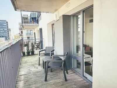 a balcony with chairs and tables on a building at Apartment with a large balcony in Kontverki