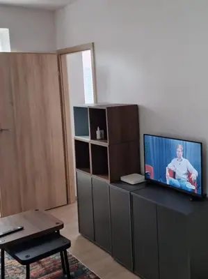 a living room with a flat screen tv on a entertainment center at Jaukus butas Pašilaičiuose in Vilnius