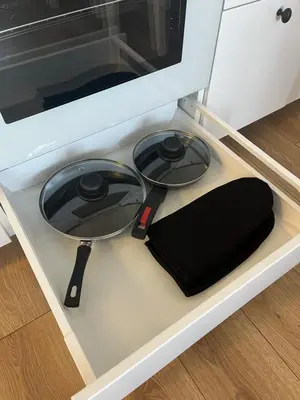 a frying pan sitting on top of a stove at Modern&bright southwest apartment in Šiauliai