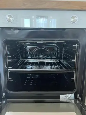 an oven with its door open in a kitchen at Modern&bright southwest apartment in Šiauliai