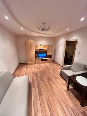 a living room with a couch and a tv in it at Family apartments in Visaginas