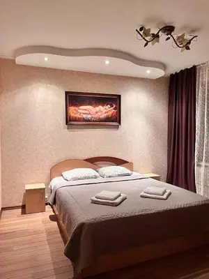 a bedroom with a bed with two towels on it at Family apartments in Visaginas