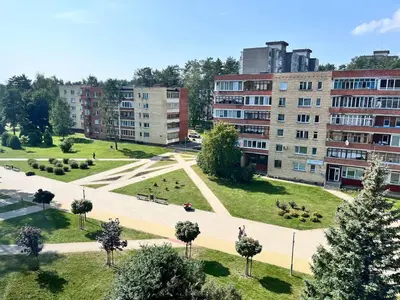 a park in the middle of a city with buildings at Family apartments in Visaginas