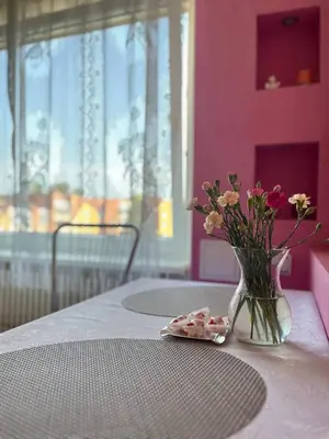 a vase of flowers sitting on top of a table at Family apartments in Visaginas