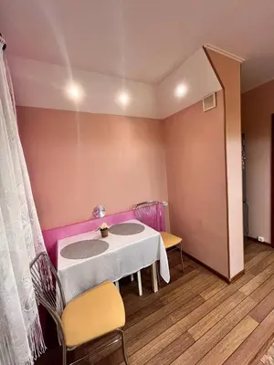 a room with a table and chairs in a room at Family apartments in Visaginas