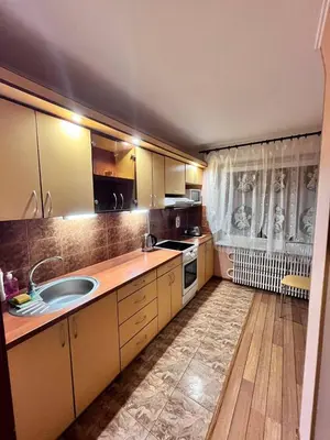 a kitchen with a sink and a counter top at Family apartments in Visaginas