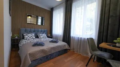 a bedroom with a bed with two towels on it at Amber Light Self-Check-In Apartments in Kaunas