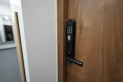 a black door handle on a wooden door at Amber Light Self-Check-In Apartments in Kaunas