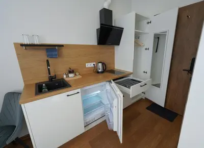 a small kitchen with a counter and a sink at Amber Light Self-Check-In Apartments in Kaunas