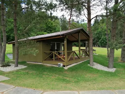 a gazebo in a park with two people in it at Jaučio apartamentai in Leliūnai