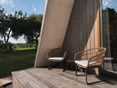 two chairs and a table on a porch at Mulberynas in Stakliškės
