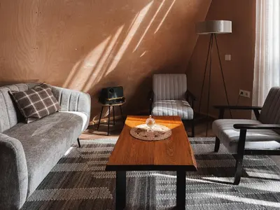 a living room with a couch and a coffee table at Mulberynas in Stakliškės
